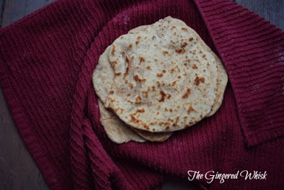 Sourdough Naan flatbread wrapped in red towel