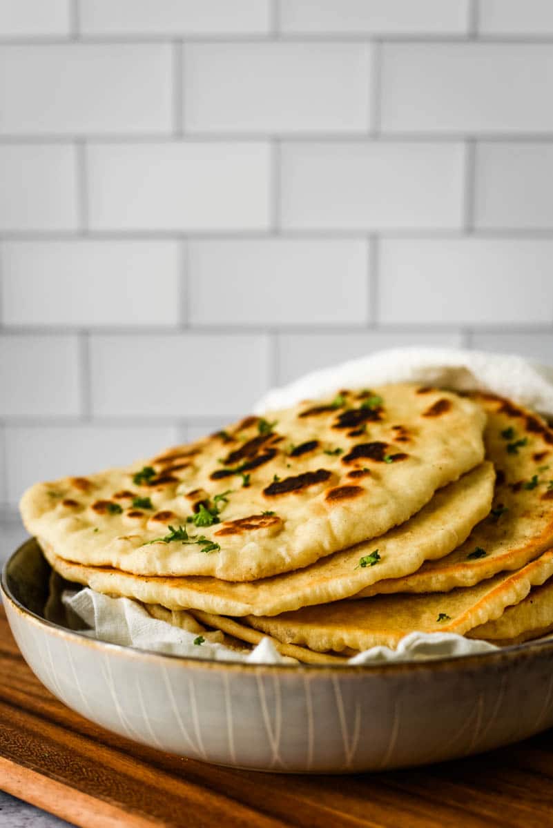 stack of sourdough naan on cutting board