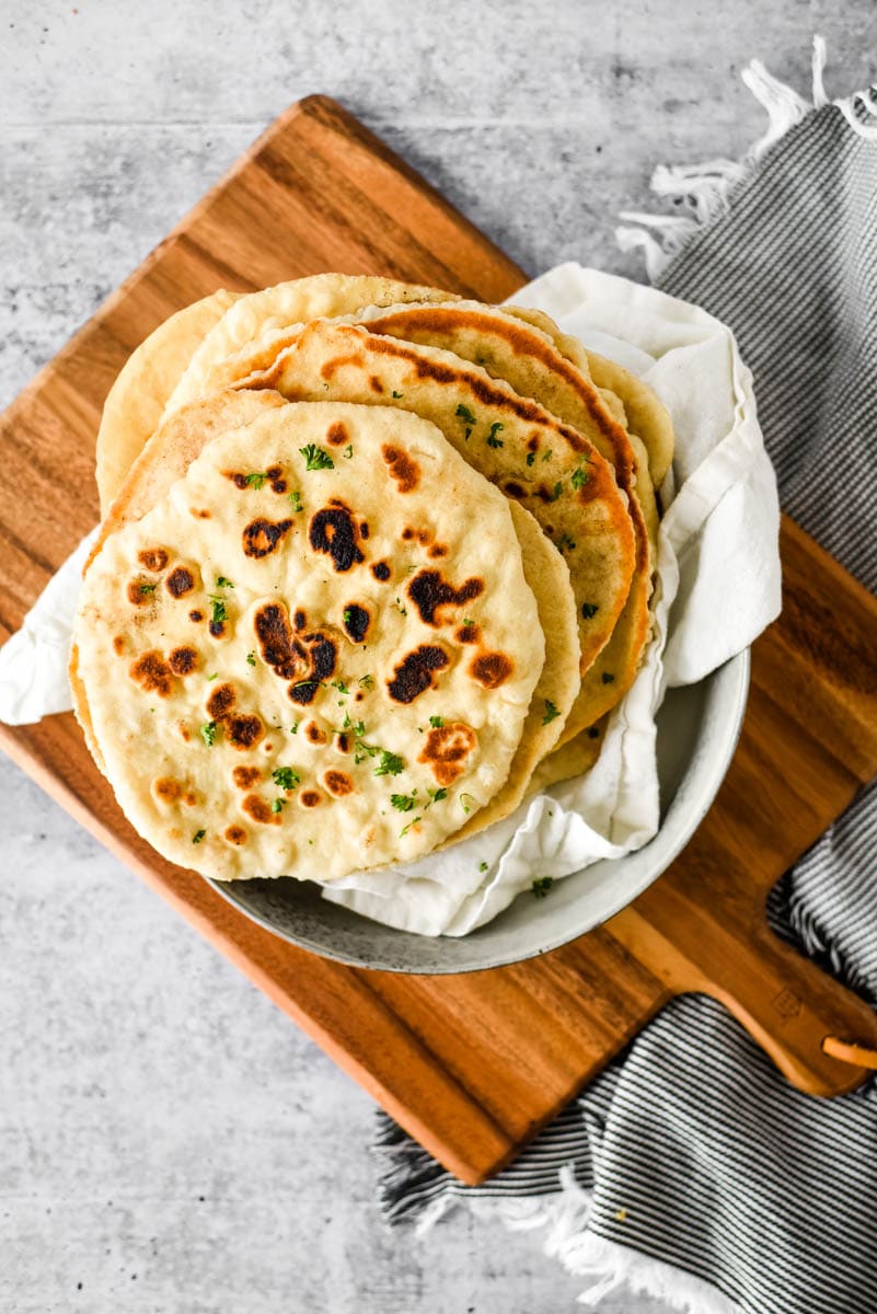 sourdough  naan on a wooden cutting board