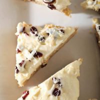 close up view of cut sourdough blondies with white chocolate drizzle