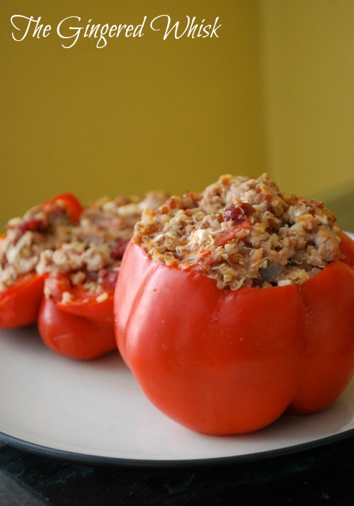 stuffed red peppers on plate with quinoa filling 