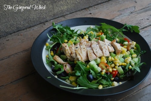 plate of salad with grilled chicken, corn, blueberries and other toppings