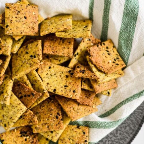 overhead close up of sourdough crackers with everything spice on white kitchen towel