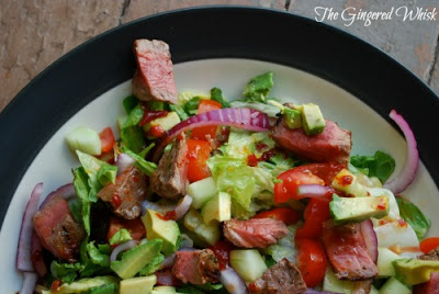 white plate featuring southwest steak dinner salad