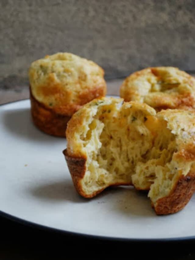 sourdough popovers on plate with one split open