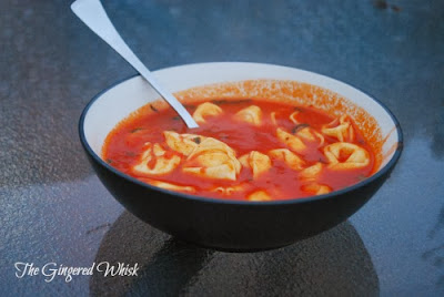 bowl of tomato basil soup with tortellini