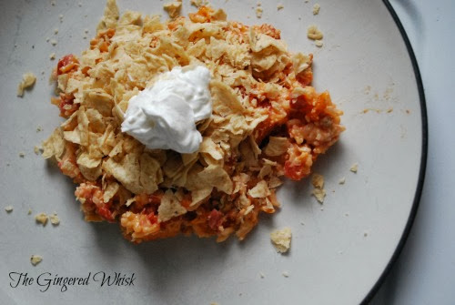 ground turkey mexican casserole topped with crushed chips and sour cream