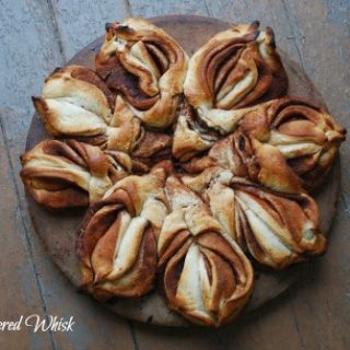 twisted cinnamon sweet bread on circle baking sheet