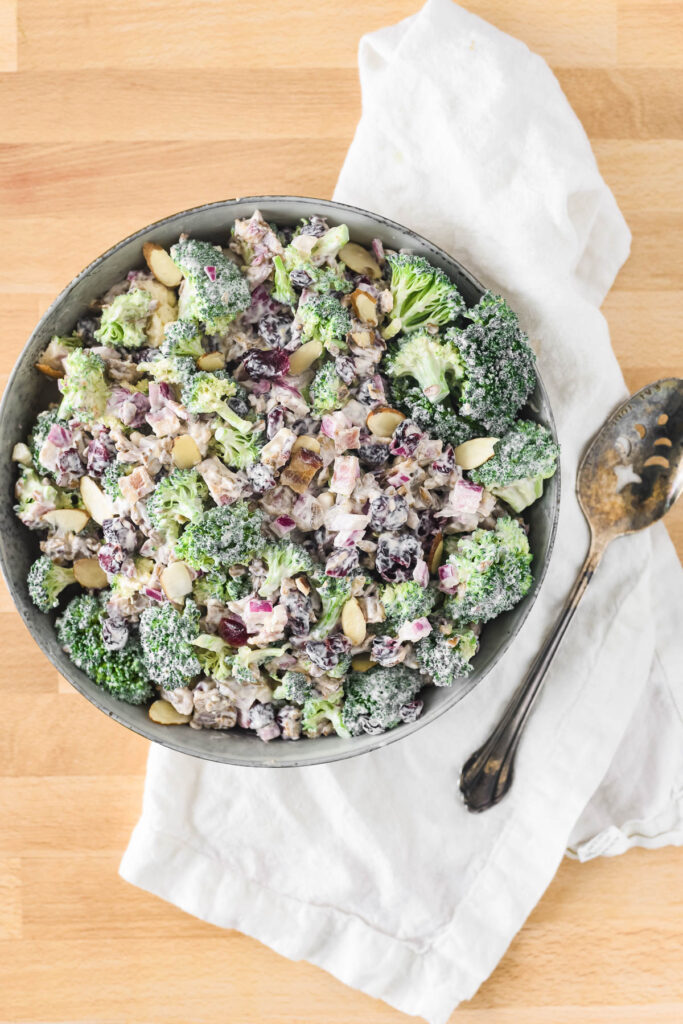 overhead image of broccoli salad with cranberries and almonds in bowl