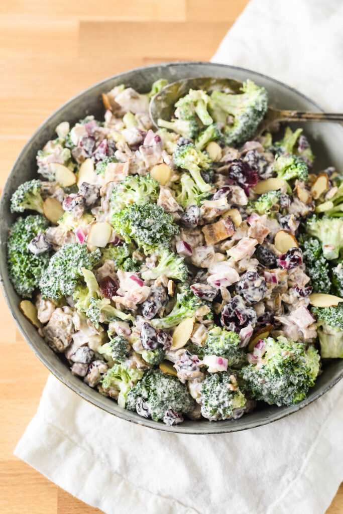 broccoli salad with greek yogurt dressing in serving bowl