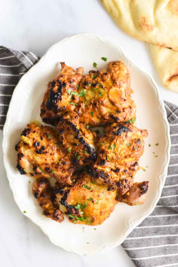 grilled indian chicken on white platter