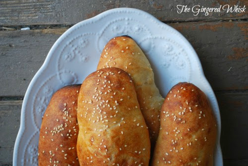 sourdough hot dog buns on white platter