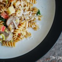 plate with pasta, chicken sausage, and apples