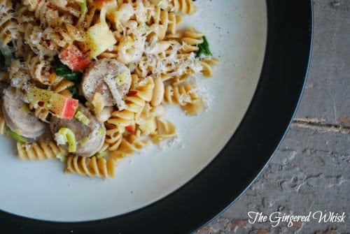 plate with pasta, chicken sausage, and apples