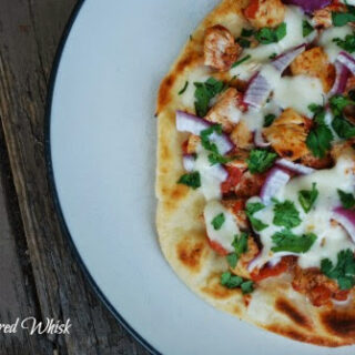 naan pizza with chicken tikka masala and cheese