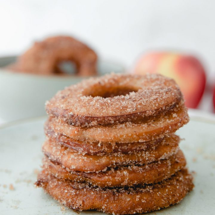 stack of fried apple rings with cinnamon sugar on plate