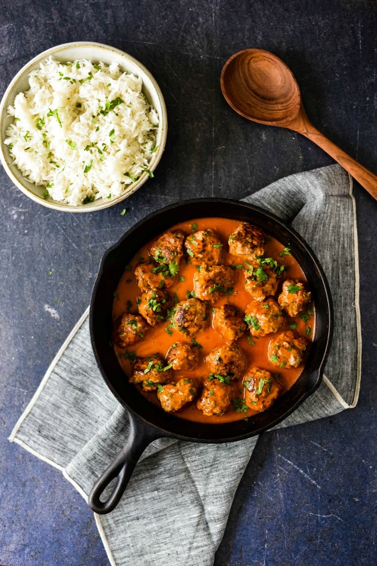 thai meatballs in cast iron skillet with bowl of rice