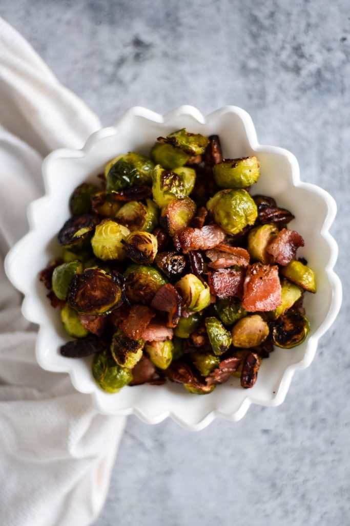 white serving bowl with Brussels sprouts and bacon