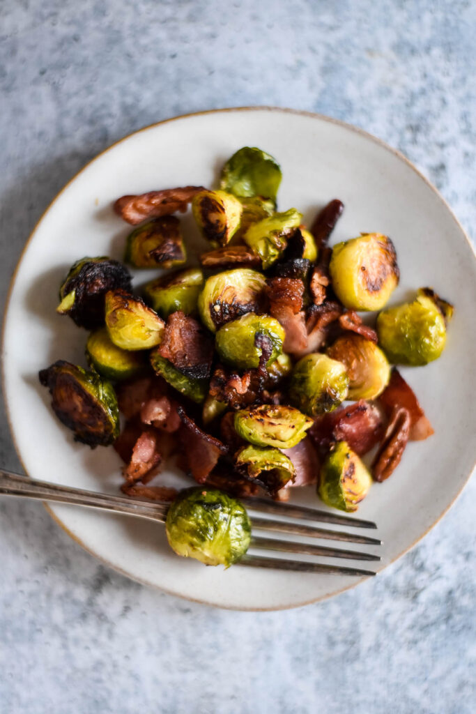 roasted Brussels sprouts on white plate with fork