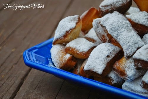 sourdough beignets piled up on blue platter