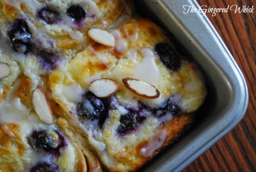 blueberry rolls in pan with almond slices
