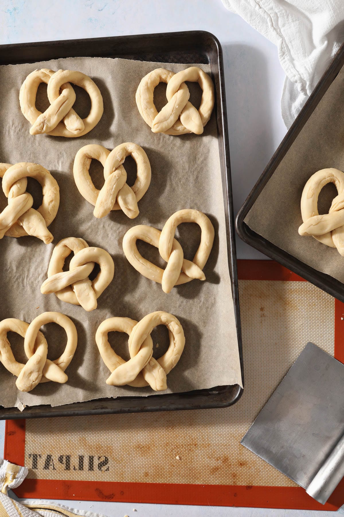 freshly shaped sourdough pretzels on tray