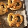 close up of sourdough pretzels on baking tray