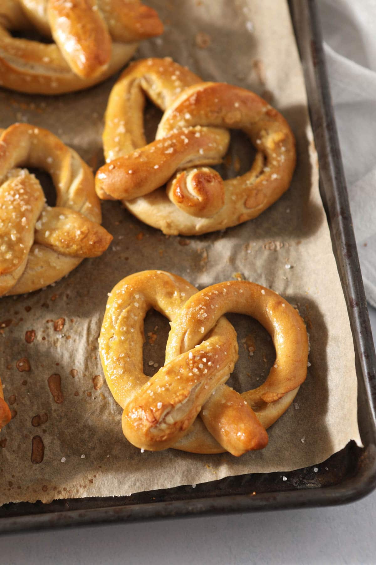 close up of sourdough pretzels on baking tray
