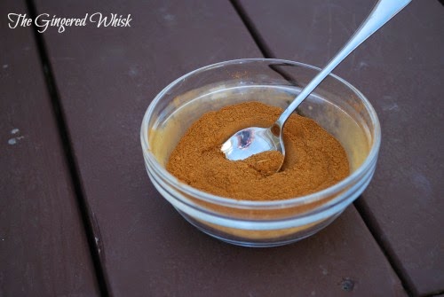 glass bowl filled with cinnabon spice mix, spoon in bowl