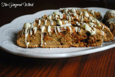 biscotti with white chocolate drizzle on white platter