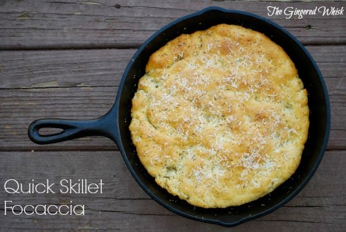 focaccia in cast iron skillet topped with parmesan cheese