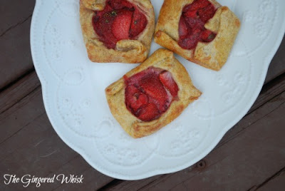 overhead view of three strawberry galettes on white plate