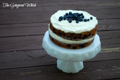 white cake stand with blueberry zucchini cake