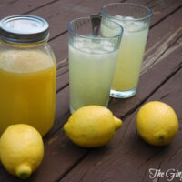 lemonade in glasses with lemons around