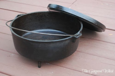 cast iron dutch oven with lid next to it