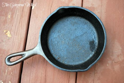 overhead view of cast iron skillet that needs to be stripped and reseasoned 