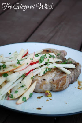 apple slaw with kohlrabi on top of pork chops