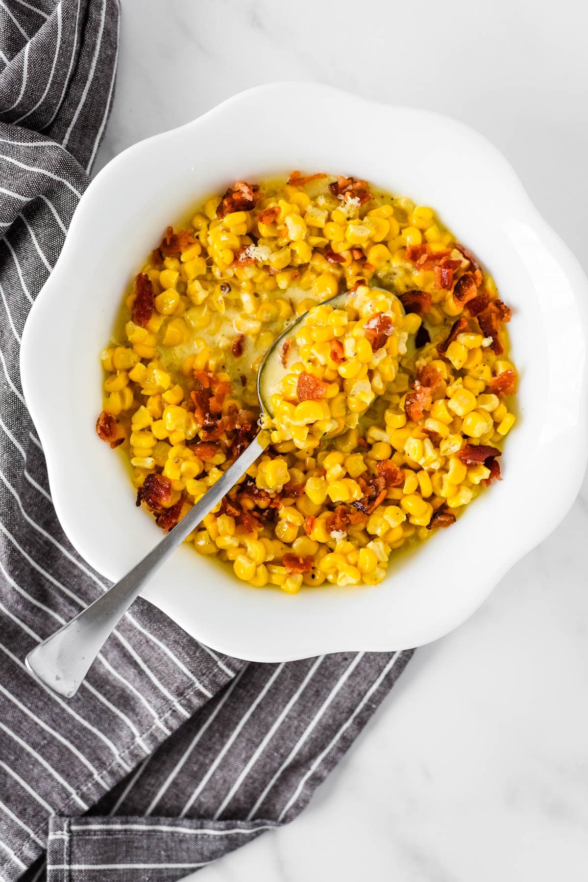 overhead view of white bowl with old fashioned creamed corn