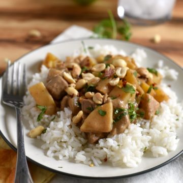 beef massaman curry over white rice on plate with fork