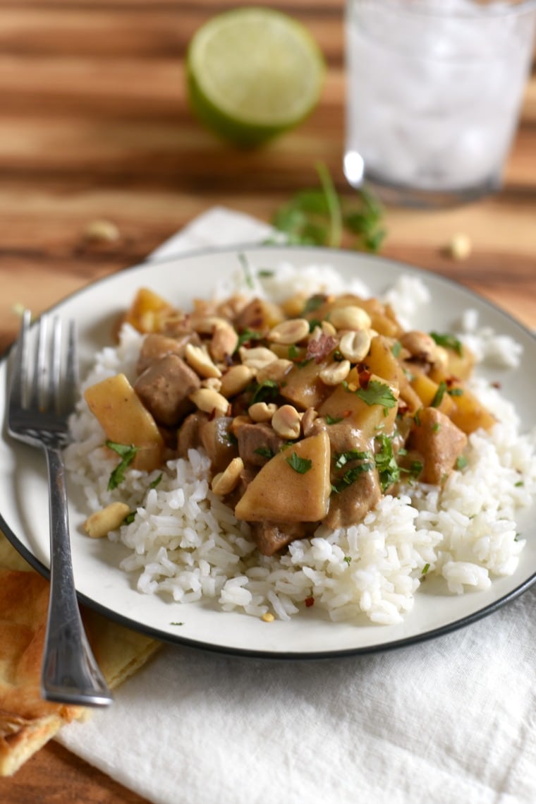 beef massaman curry over white rice on plate with fork