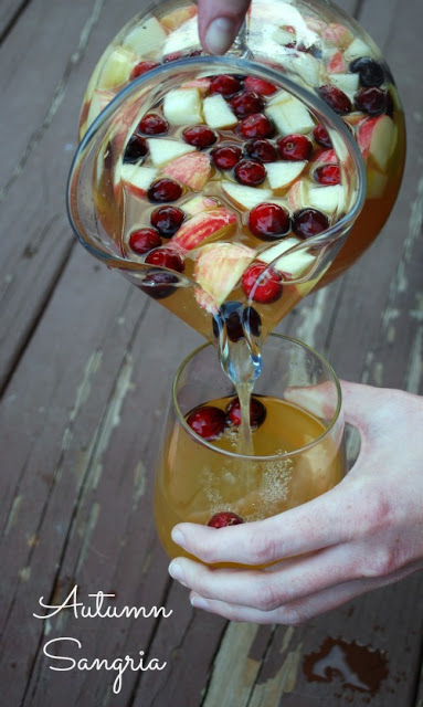 pouring autumn sangria from pitcher into glass