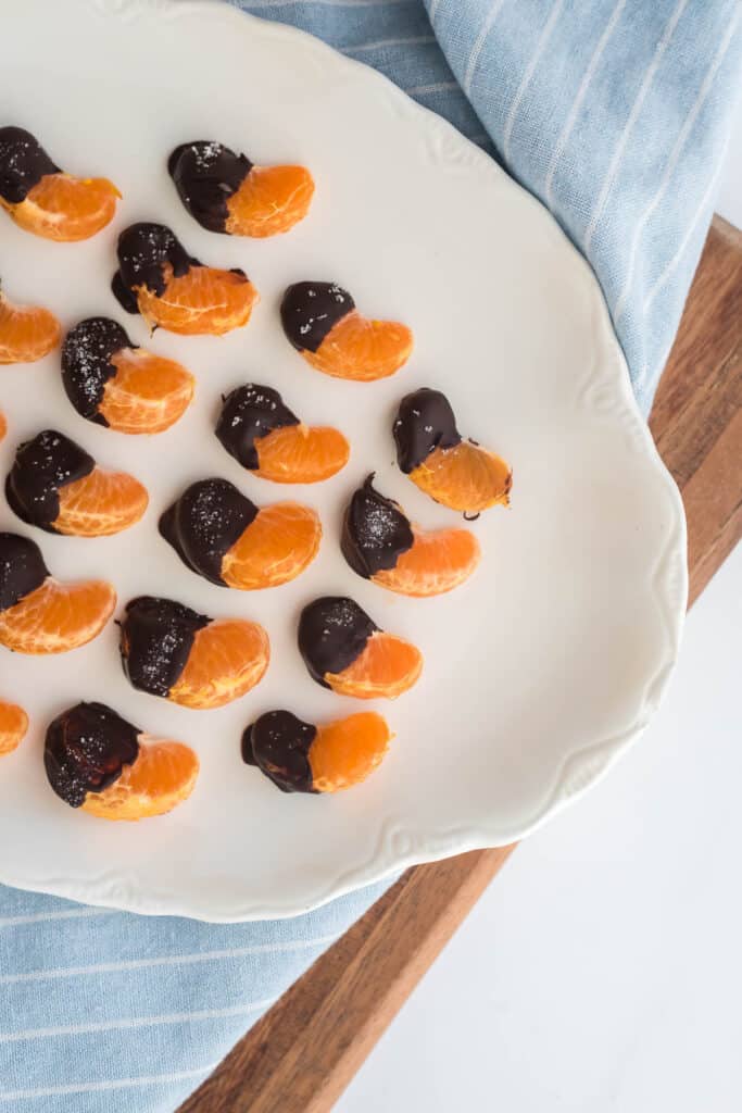 chocolate covered oranges on white platter