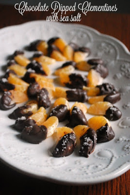chocolate dipped oranges on white platter