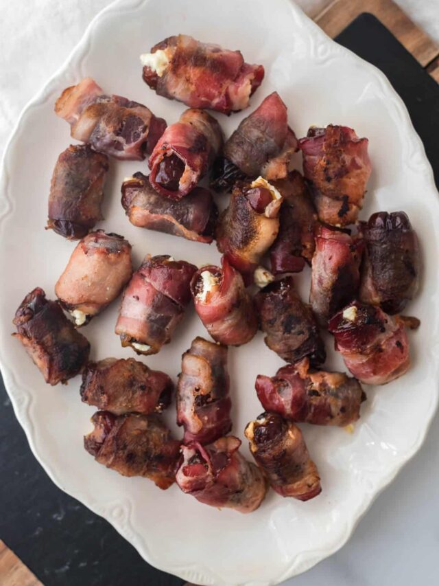 bacon wrapped dates on white platter