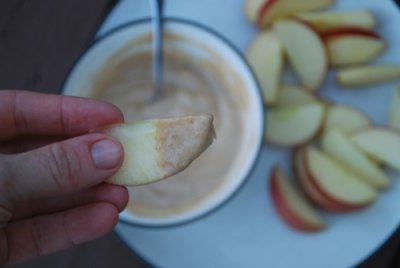slice of apple dipped in peanut butter dip