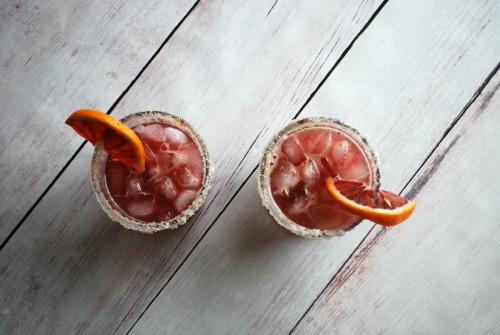 overhead view of two cocktails with blood oranges