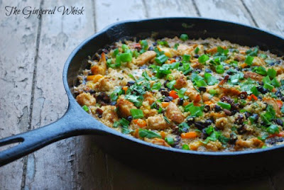 cast iron skillet with chicken quinoa casserole topped with cilantro