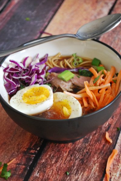 A bowl of pork ramen on a wooden table 