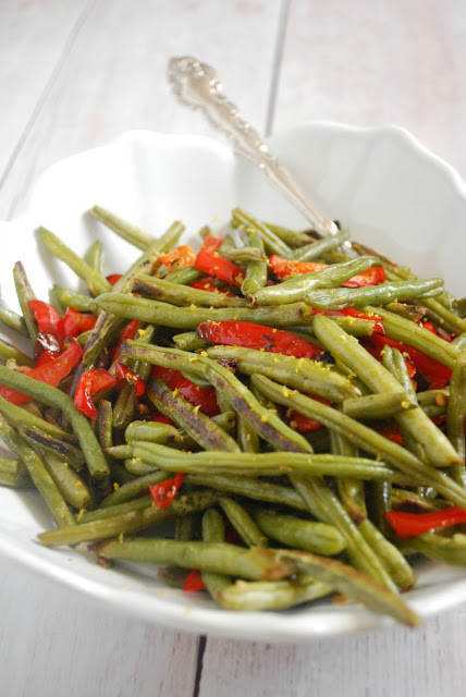 green beans and red pepper strips in white serving bowl