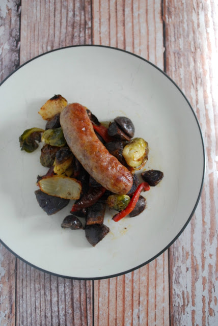 plate with roasted vegetables and bratwurst 
